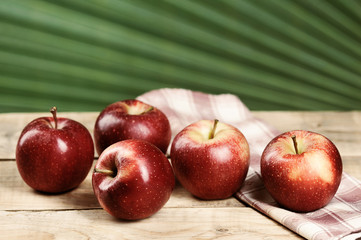 red juicy apples on wooden background