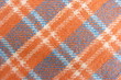 checkered wool fabric closeup drape orange white blue squares stripes geometric pattern background