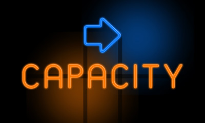 Capacity - orange glowing text with an arrow on dark background