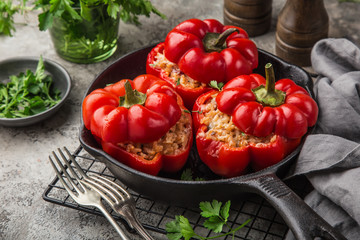 Wall Mural - red bell peppers stuffed with meat, rice and vegetables on cast iron pan