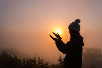 Wall Mural - Silhouette of woman hands praying to god . Woman Pray for god blessing to wishing have a better life. Christian life crisis prayer to god.