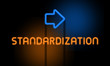 Standardization - orange glowing text with an arrow on dark background