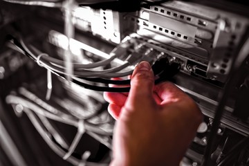 Poster - Close-Up of technician plugging patch cable in a rack mounted