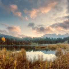 wonderful misty landscape at germanian alps. colorful clouds on blue sky over the karwendel mountain