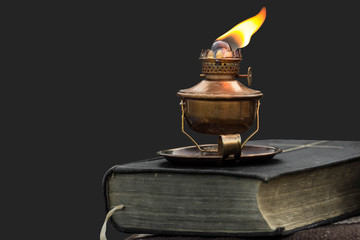 Oil lamp on old bible
