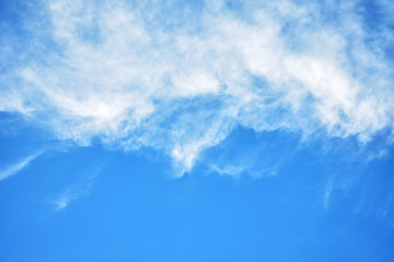 White soft fluffy clouds with blue sky background. Beautiful soft white clouds in clear blue sky, the end of rainy season.