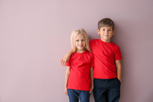 Boy And Girl In T-shirts On Color Background