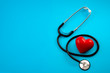© Victor Moussa - Yearly health check up, disease diagnosis medicine, healthcare and cardiology concept with a red heart and a stethoscope isolated on a hospital blue background with copy space