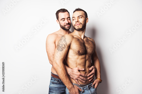 Fényképezés  Young homosexuals gay couple love each other on a white background
