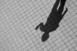 shadow of human on a brick floor - monochrome