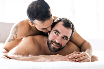 Wall Mural - A Handsome gay men couple on bed together