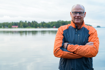 Portrait Of Happy Senior Man Smiling By The Lake