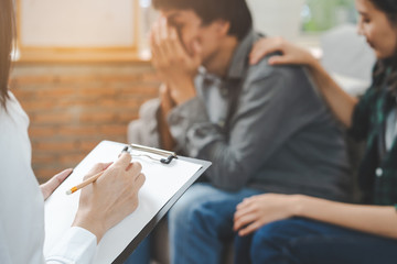 Wall Mural - psychologist talking with married couple about depression of husband.