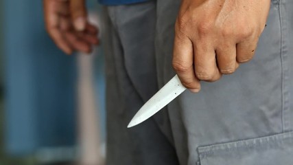 hand close up of a man holding knife
