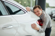 © alfa27 - Close up of adult content caucasian man being completely satisfied with his new car, hugging it with eyes closed and leaning on car bonnet