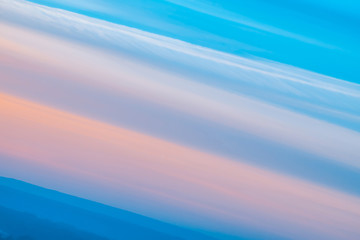 Wall Mural - varicolored striped surreal sky with shades of blue, cyan, pink colors with cobalt land. diagonal li