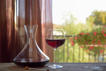 Italian red wine in goblet with decanter on natural background