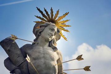 Saint Sebastian shot with arrows martyr statue, Marian plague column of Saint Rosalia, Velehrad Monastery, Moravia, Czech Republic, sunny day clear blue sky