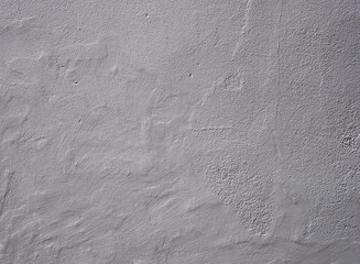 Wall Mural - light grey rough textured wall background with an uneven worn surface with cracks and a weathered surface