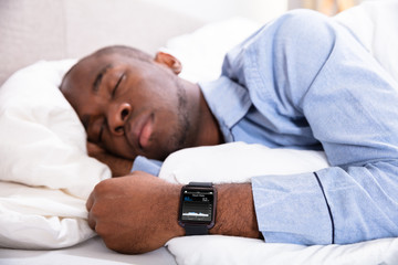 Man Sleeping With Smart Watch In His Hand
