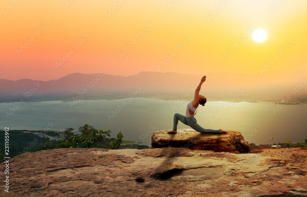 Woman practice yoga on mountain with sunset or sunrise background - obrazy, fototapety, plakaty 