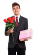 Thoughtful young happy businessman smiling while holding red ros