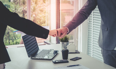 Business man and woman business couple fist bump hand together for team work