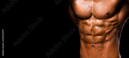 Fotomural Muscular shape male torso on black background.