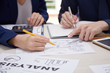 © DragonImages - Close-up of business colleagues working in team and discussing the situation on the market