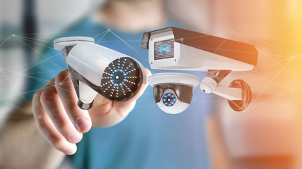 Poster - Businessman holding a Security camera system and network connection - 3d rendering
