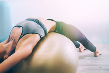 Woman Working Out With Exercise Ball In Gym. Pilates Woman Doing Exercises In The Gym Workout Room With Fitness Ball. Fitness Woman Doing Exercises For Muscle Press With Abs Swiss Ball.