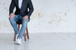 © golubovy - man in jacket and jeans sitting on a chair. confident business trainer or entrepreneur. smart casual dress code.