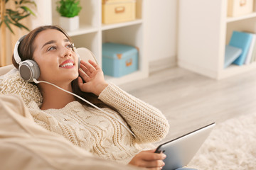 Poster - Beautiful young woman listening to music at home