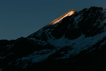 Wall Of Austrian Alps Mountains With Spotlight Of Last Sun Rays With Fresh Snow
