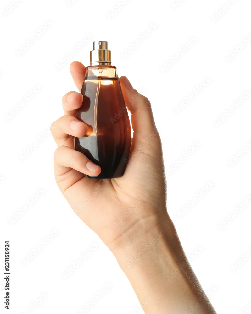 Woman holding bottle of perfume on white background