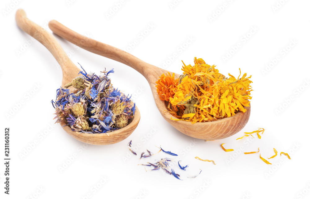 Wooden spoons with dried flowers on white background
