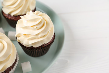 Tasty chocolate cupcakes on white table