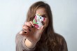 © dvulikaia - close up  toy unicorn in the hands of a woman on a white wall background