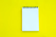 Notebook on yellow background.