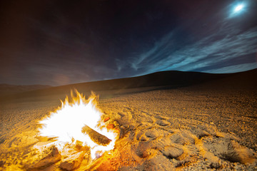 Wall Mural - While looking for meteorites at Atacama Desert we made a stop for sleeping in the middle of the amazing Atacama Desert. A camp fire under the full moon light and some stars on the cloud sky. Chile
