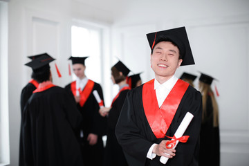 Poster - Happy student in bachelor robe with diploma indoors. Graduation day