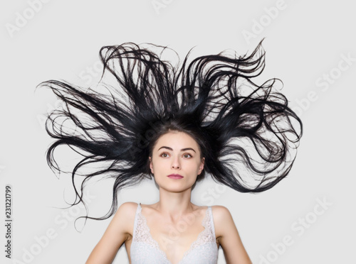 Woman Is Lying On A Light Background With Long Flowing Hair Buy This Stock Photo And Explore Similar Images At Adobe Stock Adobe Stock