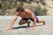 Muscular Caucasian man doing tough bear crawl workout