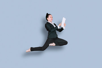 Wall Mural - Asian businesswoman dances with tablet on studio