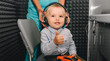 © Peakstock - little boy during the hearing exam, showing thumbs up at the audiologist's office. audiogram, children ear exam