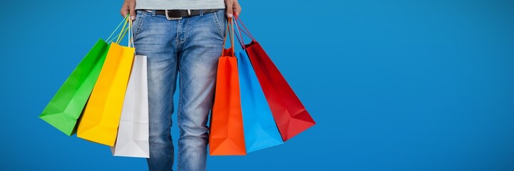 Poster - Composite image of low section of man carrying colorful shopping