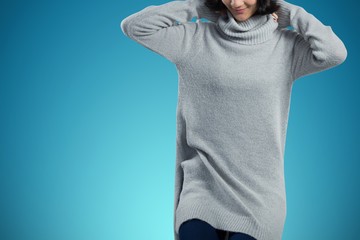 Poster - Composite image of woman in winter clothing posing against white