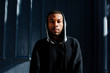 © Carlos David - Portrait of young man in hoodie