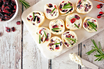 Aufkleber - Cranberry, cream cheese pinwheel appetizers. Holiday food concept. Top view, white table scene.