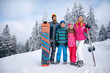 © luckybusiness - .Happy family with two children on winter vacation in mountain.